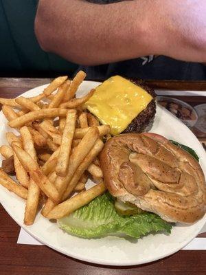 Cheeseburger on a pretzel bun with fries...