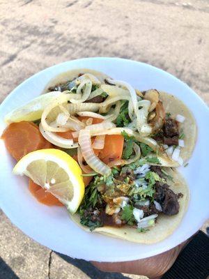 Tripas and cabeza tacos with grilled onions and pickled carrots. The best!!