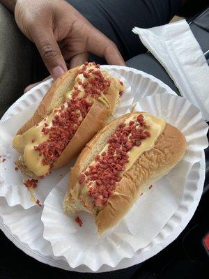 Burger dog on the left and veggie dog on the right, surfer style with deli mustard, melted real cheese, and baco' bits