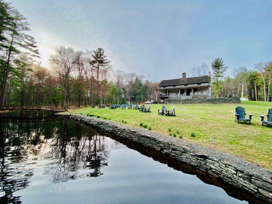 Adirondack chairs overlooking the pond.