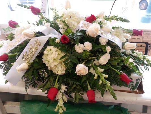 Funeral tribute with hydrangea and roses.