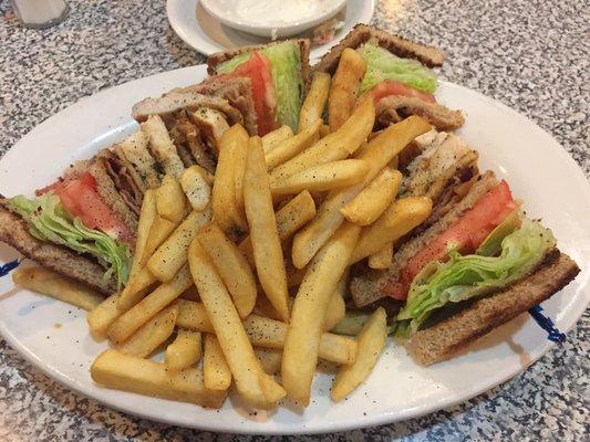 Grilled chicken, lettuce, tomato, and bacon triple decker sandwich with fries!