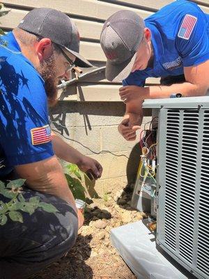 Two of our installers inspecting a system