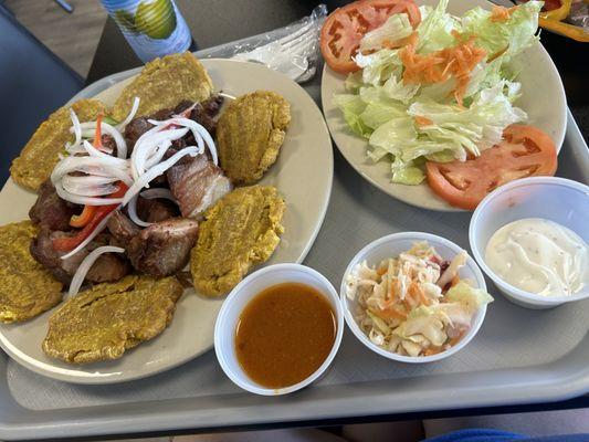 Fried pork with plantains, coleslaw, and salad.