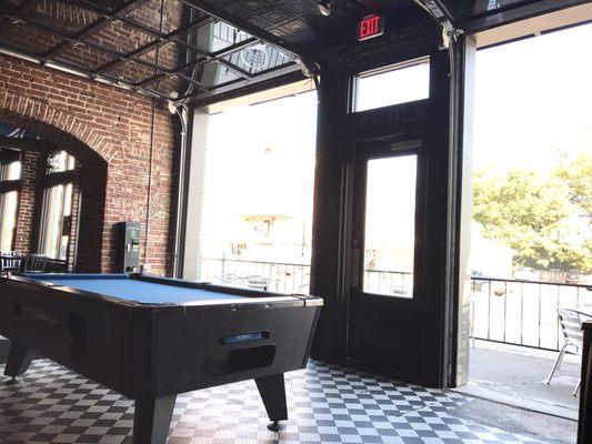 Glass garage doors that open onto the Highland strip.