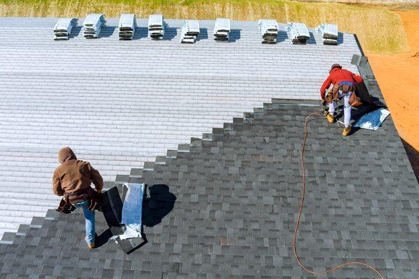 Aerial view - crews installing architectural 3-tab shingle roof.