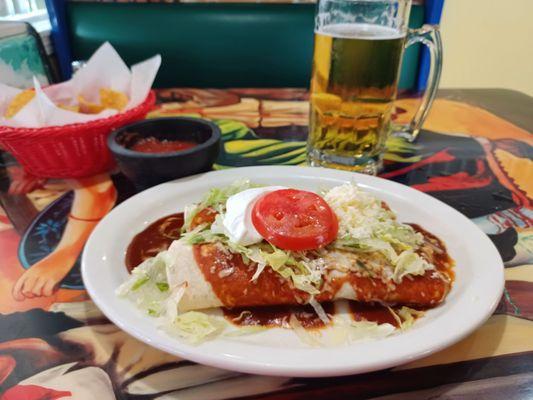 Burritos Deluxe - two chicken and bean burritos, lettuce, sour cream, a tomato slice, grated cheese and a smoky red sauce.