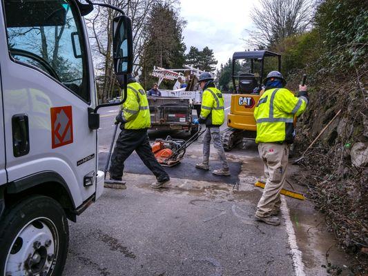 Crew cleaning up after a sewer repair street job