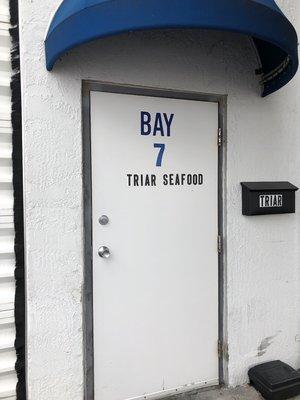 Shhhhh! Keep this secret, but there's an amazing seafood market behind that warehouse door.