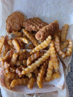 Burnt chicken nuggets and fries.