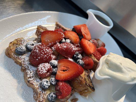 Raspberry Bread French Toast with fresh berries, pure Wisconsin maple syrup and house-made whipped cream