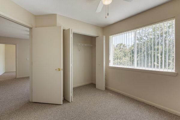 Bedroom with carpet flooring and large reach-in closet