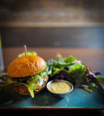 Veggie burger with avocado smash, Dijon mustard and fresh greens with lemon salad dressing. Perfect every time