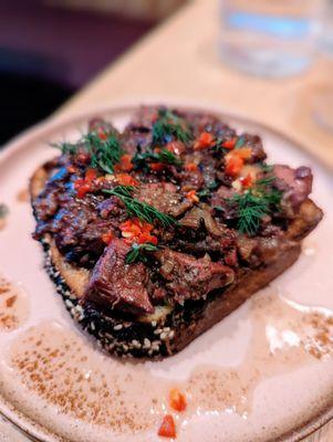 Chopped chicken liver with oyster mushrooms, vinegar, capers, brown butter and cardamom served over challah.