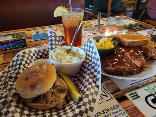 Pulled Pork Sandwich with Potato Salad $8, and Baby Back Ribs Plate with Fried Okra and Man N Cheese $19.