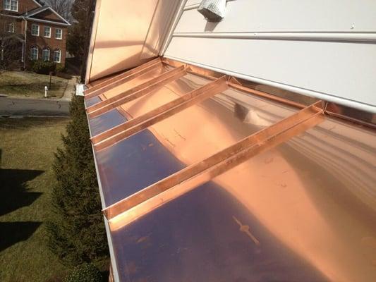 Copper Standing Seam roofing bent onsite by technicians Teddy & Willis