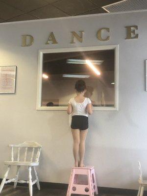 Tiny dancer watching the older ballerinas