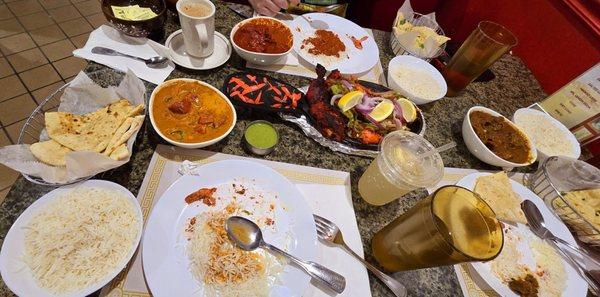 Paneer Naan, Lemon soda, Chai drink, Butter Chicken curry with rice, Chicken Tikka masala curry and goat curry. High and low spice levels