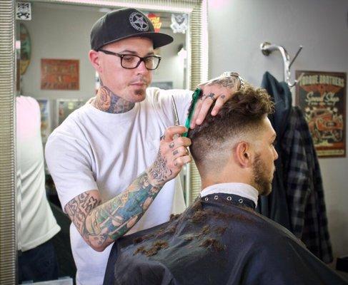 Richie creating a loose curl pompadour