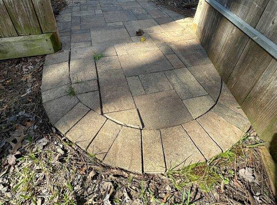 BEFORE:
 The area by the gate was in poor condition, requiring repair as the pavers were uneven and buckling.