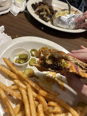 Cowboy Burger (with added jalapeños) and fries.  Hamburger steak, baked potatoes, and cabbage. (Far plate)