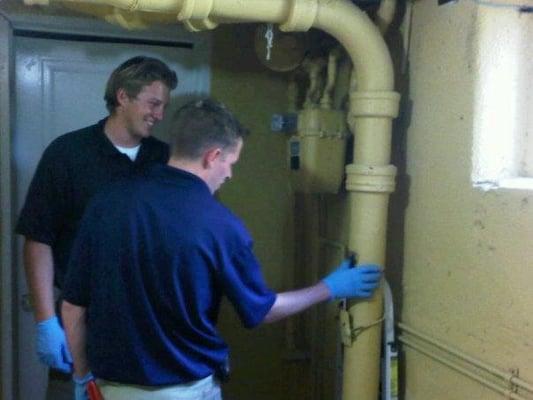 Kyle & trainee working on main drain line in old Denver home.