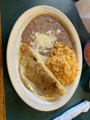 Shredded chicken folded quesadilla with rice and beans.