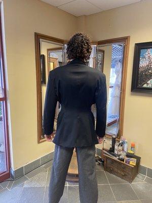 Suit fitting detailed to an S curve. Done by the waist and shown with a slightly raised hip.