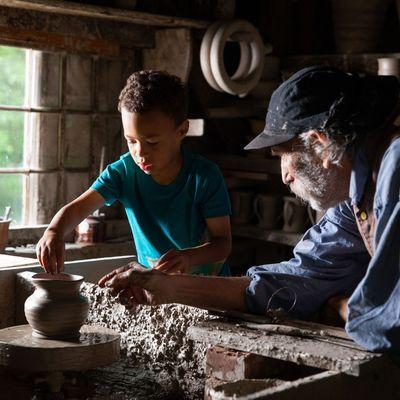 A kid tries out the Pottery Wheel