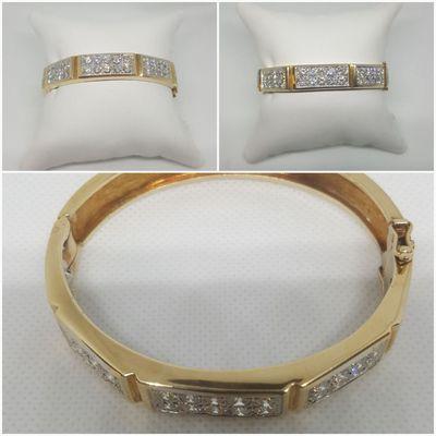 Check out our Master jewelers creation. A stunning 14k yellow gold bracelet (bangle style) with 6.13ct in diamond's.