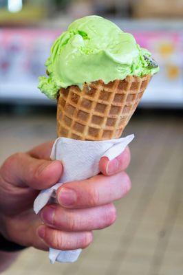 Pistachio ice cream in a cone