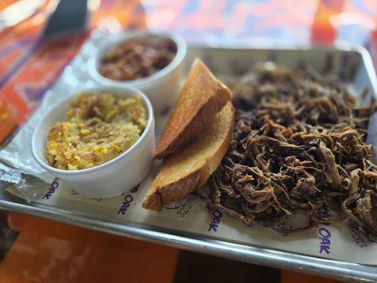 Brisket platter with baked beans and hog feed