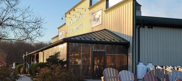 The building with outdoor seating in the summer and a heated area in the winter