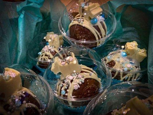 Hot Cocoa Bombs made from milk chocolate with a Belgian white chocolate puppy and sprinkles.