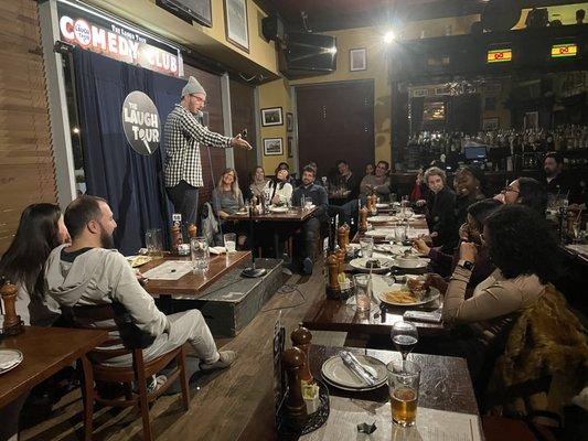 Comedian on stage pointing to person in audience