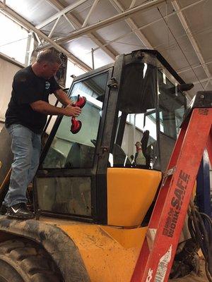 Installing glass in heavy equipment!