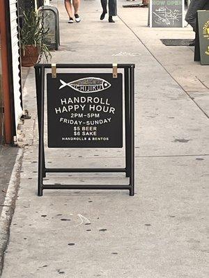 Outside advertisement of the hand roll happy hour!