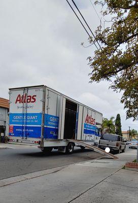 Atlas Moving truck (Gentle Giant) outside of apartment, with the ramp down, in between furniture moving trips.