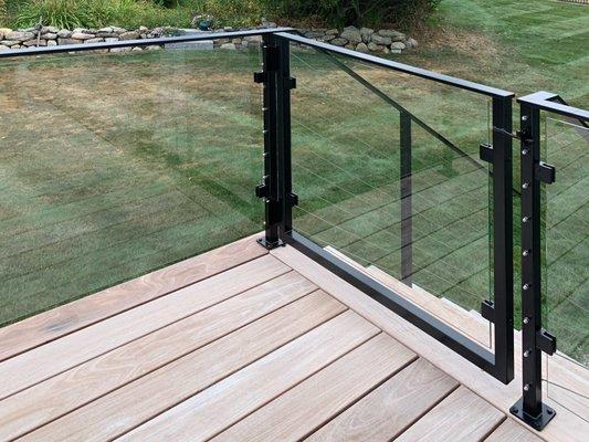 AGS manufactures custom railing systems. This cable and glass railing install has a custom-designed gate and a black powder coat handrail.