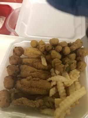 Cat fish fillets, fried okra, French fries, bread, hush puppies, onion and pickle