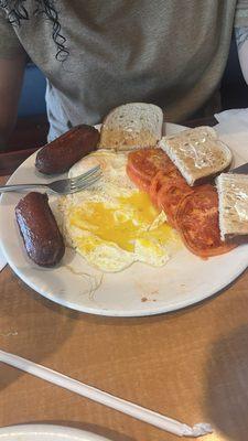 3 eggs, Sausage, tomatoes, rye toast with butter.