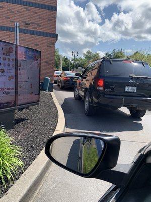 The SUV ahead of me just climbed the curb and left the line.