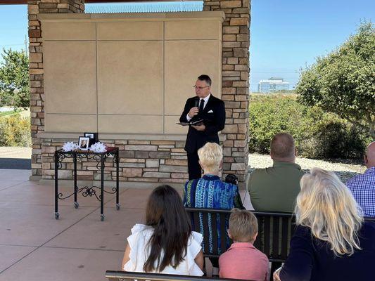 Chaplain Jeff Saville, Miramar National Cemetery, leading a graveside committal aka military funeral. See the Honor Display made by family.