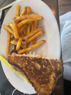 Reuben sandwich, fries and a wilted pickle