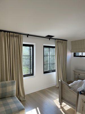 Custom roman shades and room darkening draperies with the same fabric.  Pacific palisades home