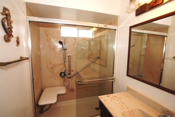 Special needs shower with fold down seat, grab bars, and handheld with slidebar for handheld shower head.