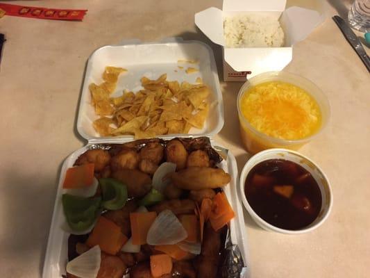 A feast. Sweet and sour chicken with orange chicken sauce instead of sweet and sour sauce. Egg drop soup. Rice. Won ton chips.