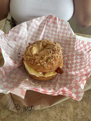 Bacon Egg and Cheese with chive cream cheese on an Asiago Bagel.