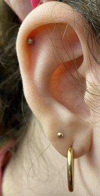 star stud helix piercing and gold stud second lobe piercing by maria tash