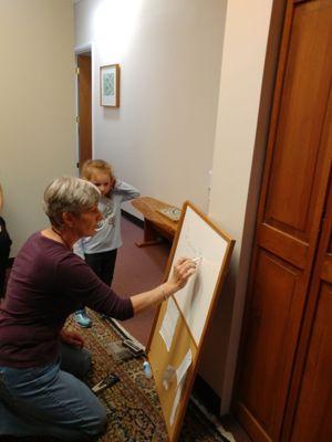 Jane drawing the HP logo